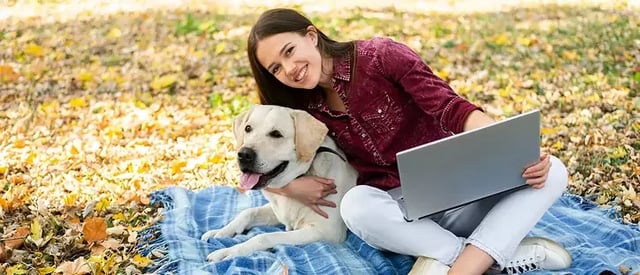 Student studying with ESA dog in dorm room