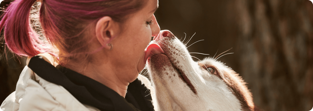 A woman embracing a fluffy dog