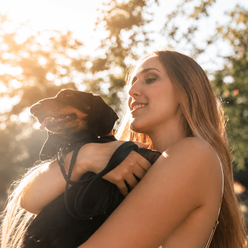 Woman hugging her emotional support dog