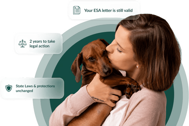 Woman holding her emotional support dog
