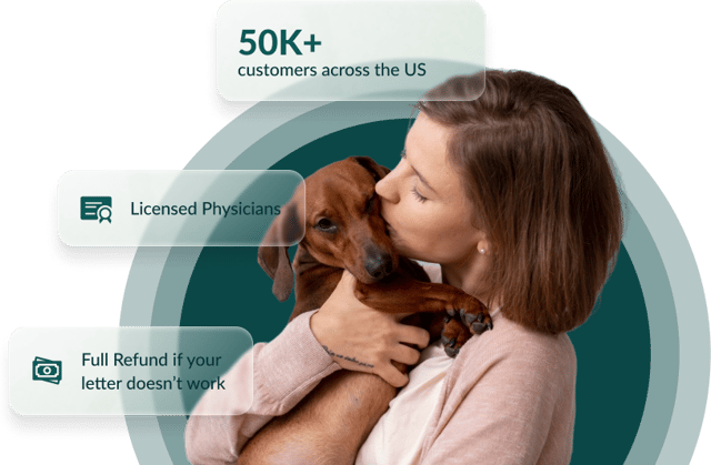A man affectionately holding his emotional support dog